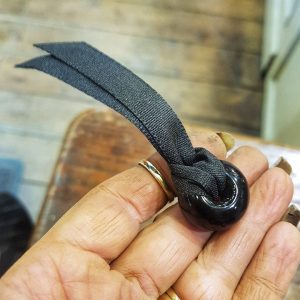 Whitby Jet bead held by Whitby Jet craftsmen