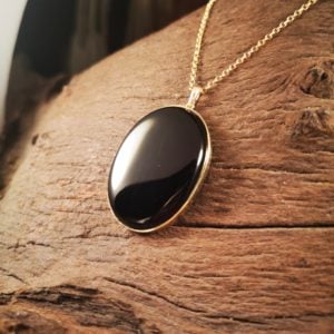 Oval shaped gold Whitby Jet pendant.