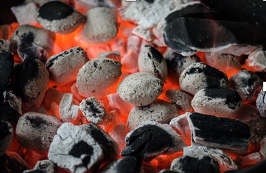 Hot barbeque coals on a beach