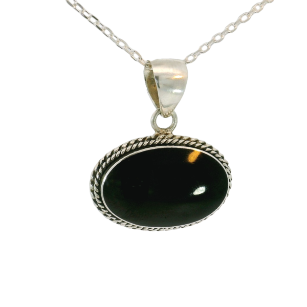 A large Whitby jet oval pendant with a hint of classic design and style